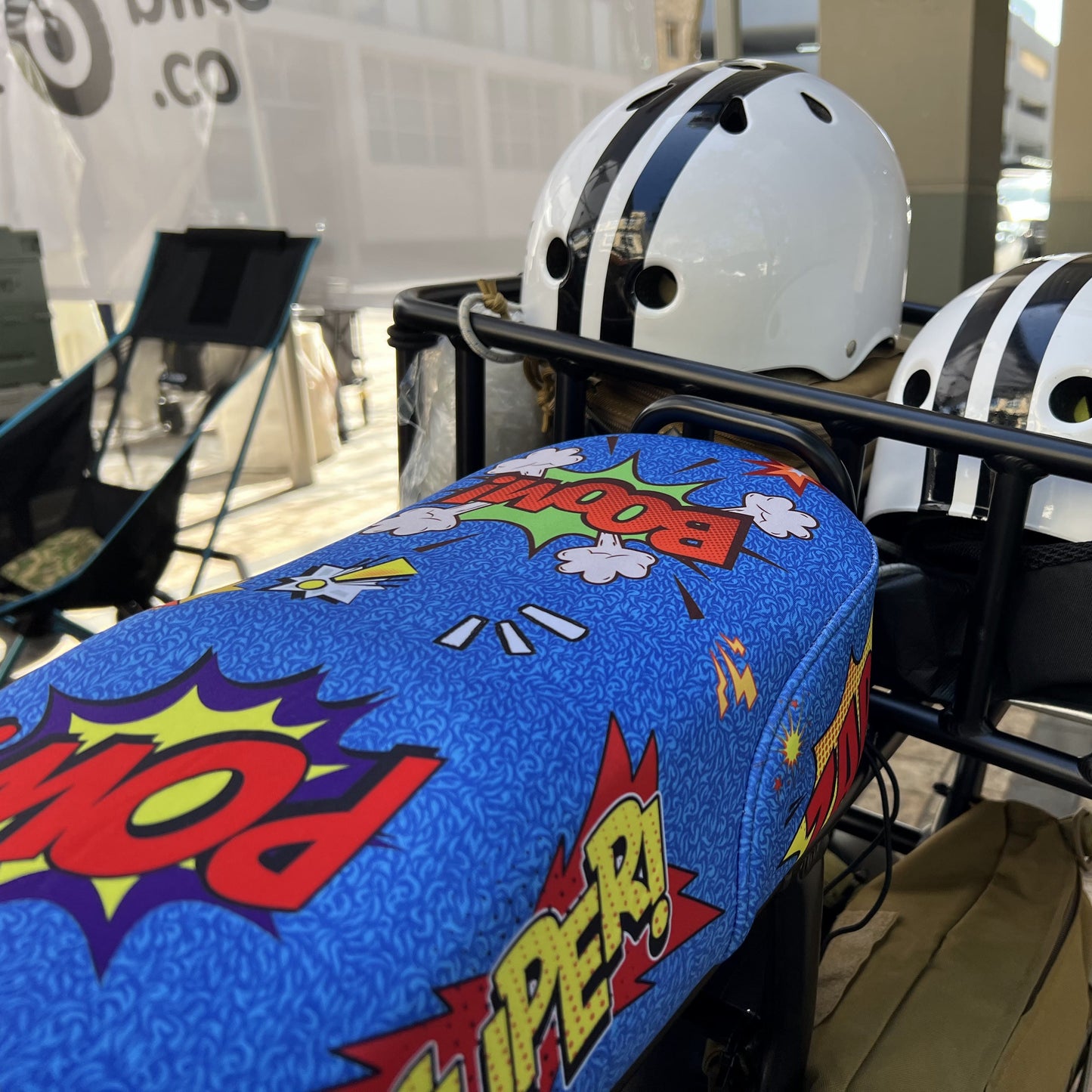 Comic Blast DiroDi Rover, Stator, Ampd Bros & Fatboy seat cover with vibrant comic-style graphics, soft neoprene, and bum protection for bold, comfy rides.